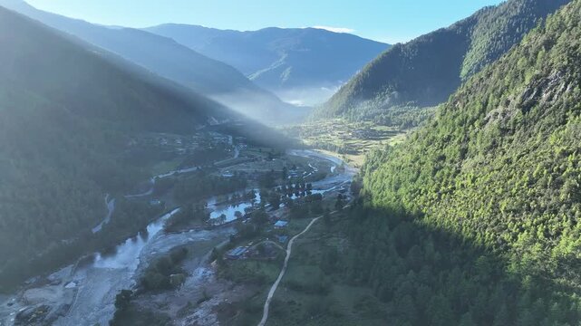 Aerial view of the lush Haa Valley, where a winding river cuts through the landscape, bordered by verdant hillsides, Haa, Haa, Bhutan.