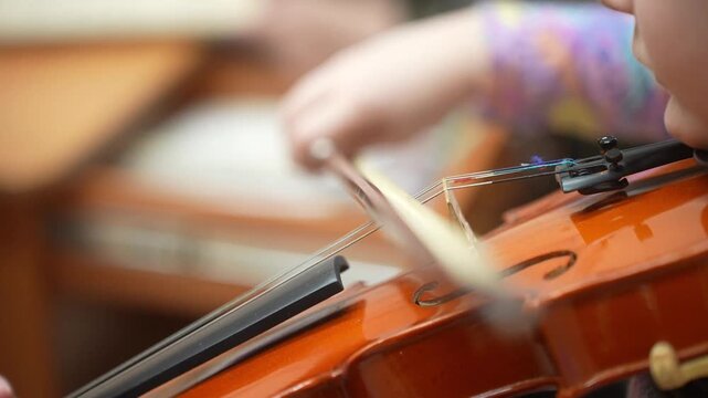 The Girl plays and trains the violin at a music school. A child's violin lesson. High quality video