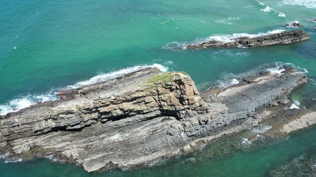 Aerial view of the rocky coastline meeting the turquoise waters of the Atlantic ocean, a scenic view in Zambujeira do Mar, Beja District, Portugal.