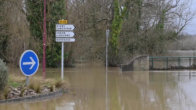 Aerial view of floodwaters engulfing road signs pointing towards Cadillac-sur-Garonne, Nouvelle-Aquitaine, France.