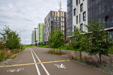 A pedestrian sidewalk combined with a bike path on a street in a modern city. A view of new residential complexes. Innopolis, Republic of Tatarstan, Russia.