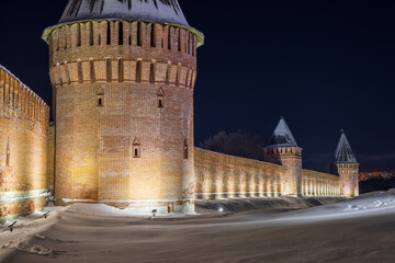 Smolensk Fortress Wall, Smolensk, Smolensk Oblast, Russia. Evening view of the fortress towers and walls. Night illumination of the ancient fortifications. Tourist attraction.