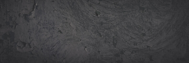 Dark wide panoramic background. Peeling paint on a concrete wall. Faded dark texture of old cracked flaking paint. Weathered rough painted surface with patterns of cracks. Shaded background for design