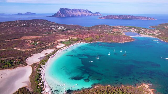 Sardinia Lu Impostu 4K drone. Turquoise sea contrast with salt lake and beach. Aerial view of San Teodoro coastline. Mediterranean summer nature travel footage Sardegna