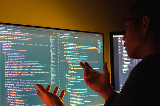 Programmers are presenting computer code development work to create systems for organizations using JavaScript and C++ programming languages, and testing to ensure the systems function efficiently.
