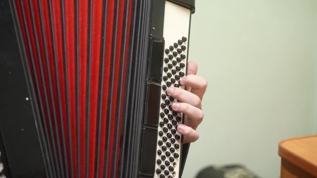 A boy plays the accordion in a music school lesson. close-up. High quality video
