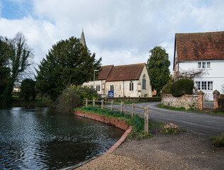A rural Hampshire village depicting church and village pond.