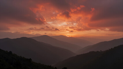 Breathtaking Mountain Range at Sunset with Dramatic Orange Clouds and Layered Peaks Silhouetted Against a Fiery Sky, Perfect for Travel or Nature Backgrounds