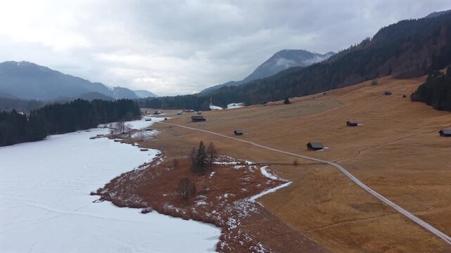 High angle aerial of the snowy Wagenbruchsee in Kruen. Geroldsee is a must-see for tourists in the Bavarian Alps. Beautiful winter nature footage of the Garmisch region.