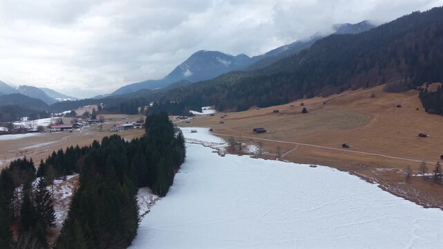 Top-down view of the frozen Wagenbruchsee in winter. Located in the Kruen alpine region Germany. Geroldsee is a highly sought-after destination for winter sports and tourism.