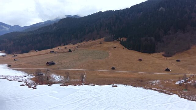 Aerial view of snowy Wagenbruchsee in Kruen. This Geroldsee landscape is a classic Bavarian tourism icon. Winter mountains and frozen lake scenery in Upper Bavaria Germany.