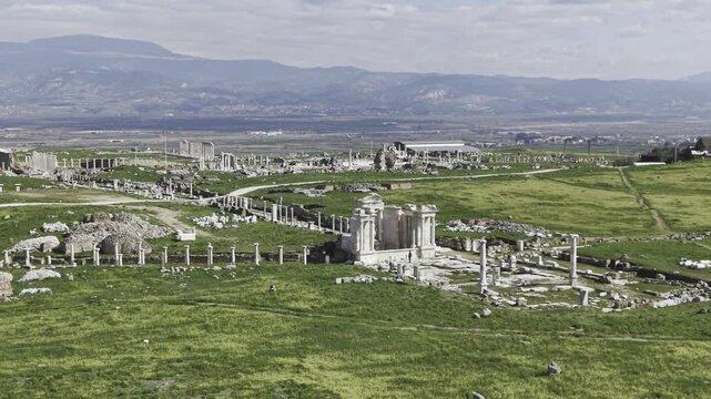Cinematic aerial drone video footage of Laodikeia Antik Kenti in Denizli, Turkey, featuring ancient ruins, stone structures, and wide historical landscape from above in the Aegean region.