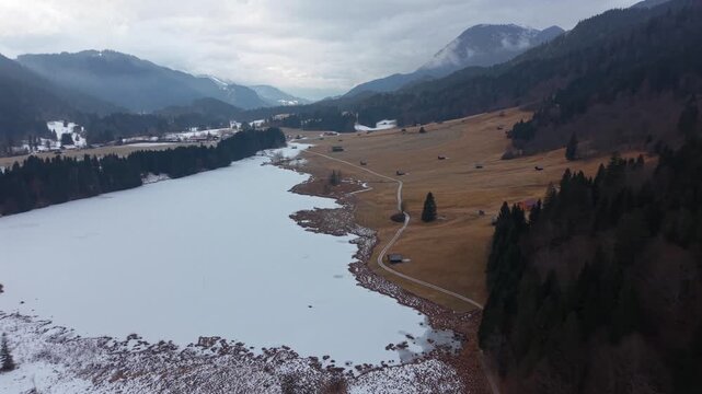Winter aerial of Wagenbruchsee also called Geroldsee in Kruen. A famous tourist destination in the Alps. Snowy lake view in the Karwendel Nature Park Upper Bavaria.