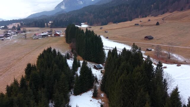 High-altitude drone shot of Geroldsee in Kruen. The snowy Wagenbruchsee is a famous destination in the Karwendel Alps. Essential winter stock footage for German travel themes.