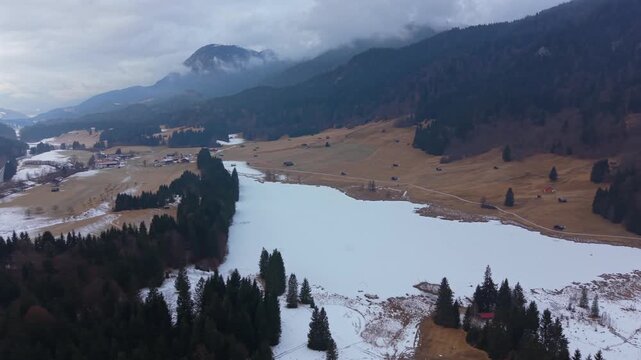 Birds eye view of the frozen Wagenbruchsee in Kruen, Germany. A snowy alpine lake in the Karwendel Nature Park. A must-visit tourist destination for winter landscape lovers.