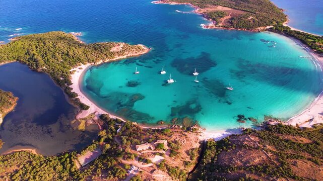France Corsica Rondinara beach golden hour 4K. Perfect round bay aerial drone. Turquoise water and white sand. Mediterranean summer travel. Bonifacio coastline