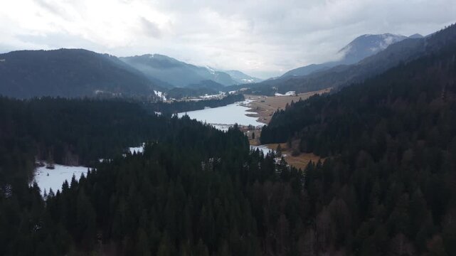 Aerial winter panorama of Wagenbruchsee in Kruen Upper Bavaria. Snowy Geroldsee is a popular destination for nature lovers. Scenic alpine view near Garmisch-Partenkirchen.