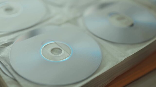 Collection of DVD and CD discs stored in a folder.