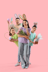Obraz premium Happy family in bunny ears with Easter gifts on pink background