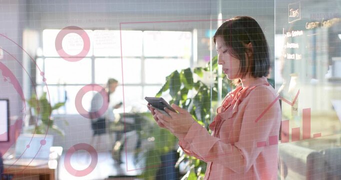 Animation of graphs, globe, loading circles over asian woman scrolling on digital tablet in office