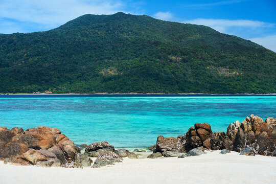 Turquoise clear sea and white sand beach on tropical island