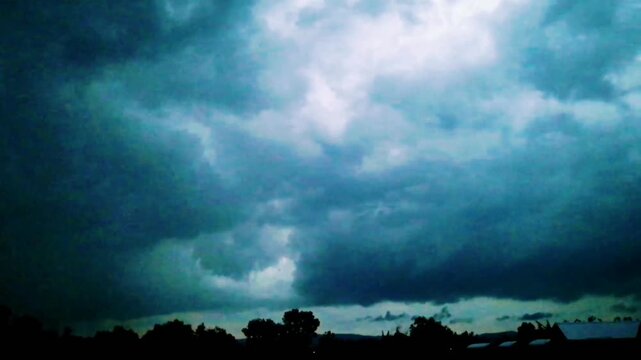 Tropical clouds stormy day time, in dark evening time, big rain clouds rolling, typhoon clouds after tornado. Intense rotating supercell thunderstorm, with impressive lightning strikes. Nature landsca