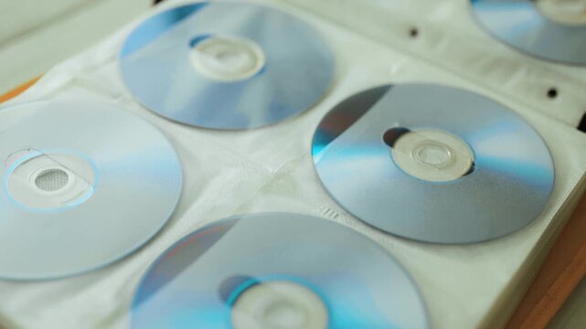 Collection of DVD and CD discs stored in a folder.