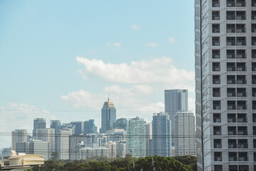 Fototapeta premium Cityscape and skyline. Buildings right next to each other and overlapping in the view. Urban development and progress.