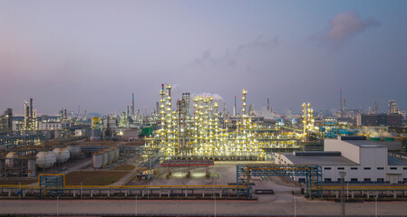 Fototapeta premium Refinery and chemical plant complex illuminated by night lights