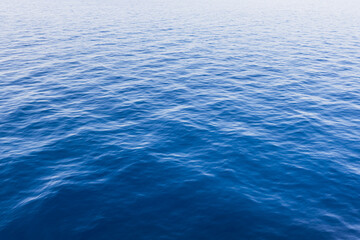 Calm deep blue ocean water with gentle ripples.