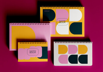 Four Spiral Notebooks Mockup Arranged in Layered Composition