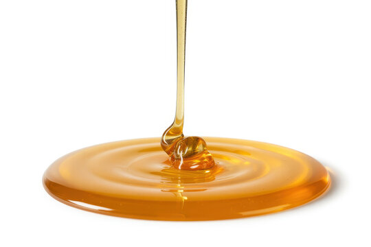 Honey pouring onto a puddle of honey golden syrup liquid