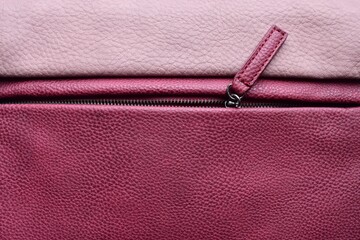 Pink leather bag. Detail of a colored leather bag with a zipper © LineDP