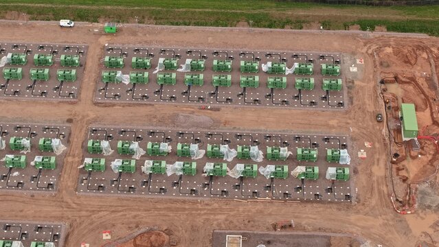 Aerial view of the new Battery Energy Storage Systems BESS at National Grid Hams Hall Substation, a symphony of green and earth tones against the horizon, Birmingham, United Kingdom.