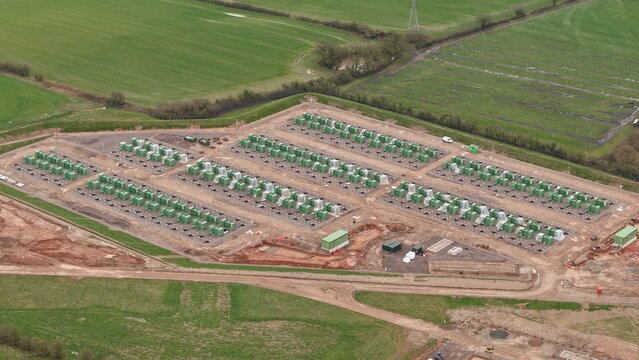Aerial view of a Battery Energy Storage Systems BESS site at National Grid Hams Hall Substation, where rows of containers gleam under the sky, Birmingham, United Kingdom.