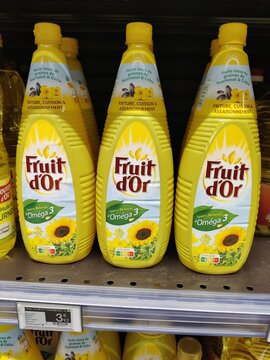 Saujon, France - January 24, 2026: Intermarche. Three bottles of Fruit d'Or cooking oil with Omega 3 displayed on a supermarket shelf, bright yellow packaging and sunflower graphics visible