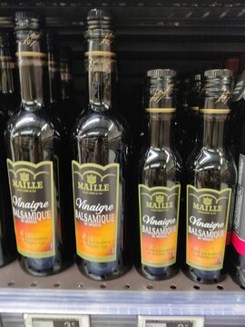 Saujon, France - January 24, 2026: Intermarche. Maille balsamic vinegar bottles displayed on a supermarket shelf, featuring distinct labels and varying sizes for consumer selection