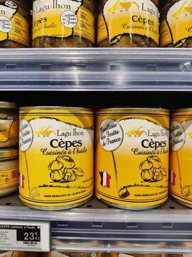 Saujon, France - January 24, 2026: Intermarche. Canned Cepes mushrooms in yellow packaging displayed on supermarket shelf, brand Laguilhon visible with price tag
