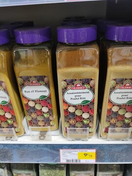 Saujon, France - January 24, 2026: Intermarche. Ras el Hanout spice jars on a supermarket shelf, featuring colorful labels and purple lids, priced at $9.75 each