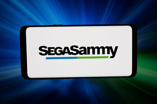 Stuttgart, Germany - 02-27-2026: In this photo illustration, the logo of Japanese company Sega Sammy Holdings Inc. is displayed on a smartphone in front of abstract background on computer screen.
