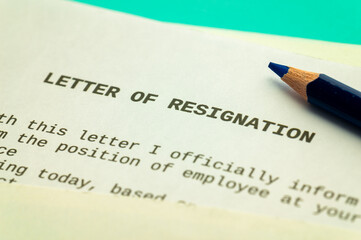 Employee resignation letter and pen beside. 
