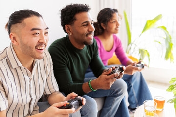 Friends enjoying video game console playing together at home