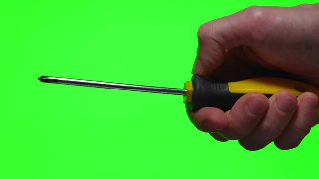 A yellow screwdriver in a hand against a green background.
A steel industrial tool.
A Phillips-head screwdriver in a hand.