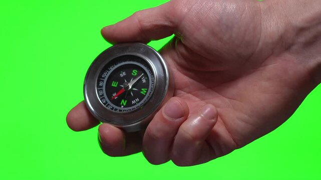 compass in hand on a green background