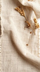 Obraz premium Tan Burlap Fabric with Golden Wheat Stalks on White Tabletop