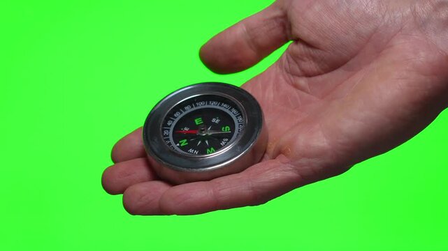 compass in hand on a green background