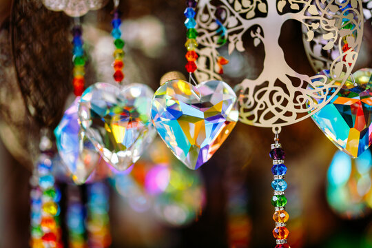 Colorful crystal heart suncatchers with tree of life design reflecting vibrant light