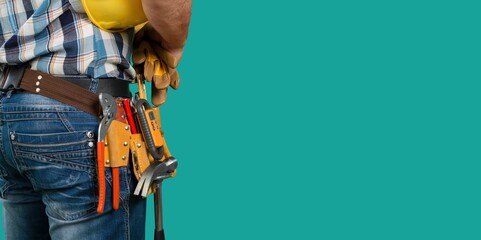 Worker man with tool belt on color background