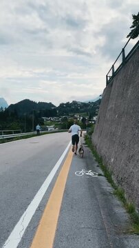 Running with Dog in Italian Mountain Town

Young man jogging with dog through Italian alpine town, active lifestyle, summer fitness, sport tourism in the mountains.
