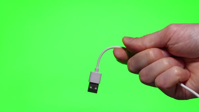 USB cable close-up in hands on isolated background